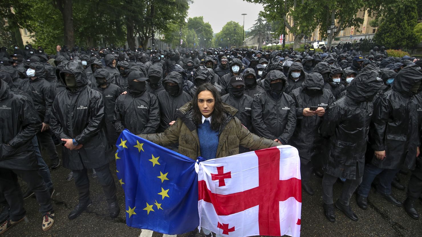 A protester holds an EU and Georgian flag in front of riot police at a demonstration against the proposed 'foreign agents' law in the capital Tbilisi, on May 14.
