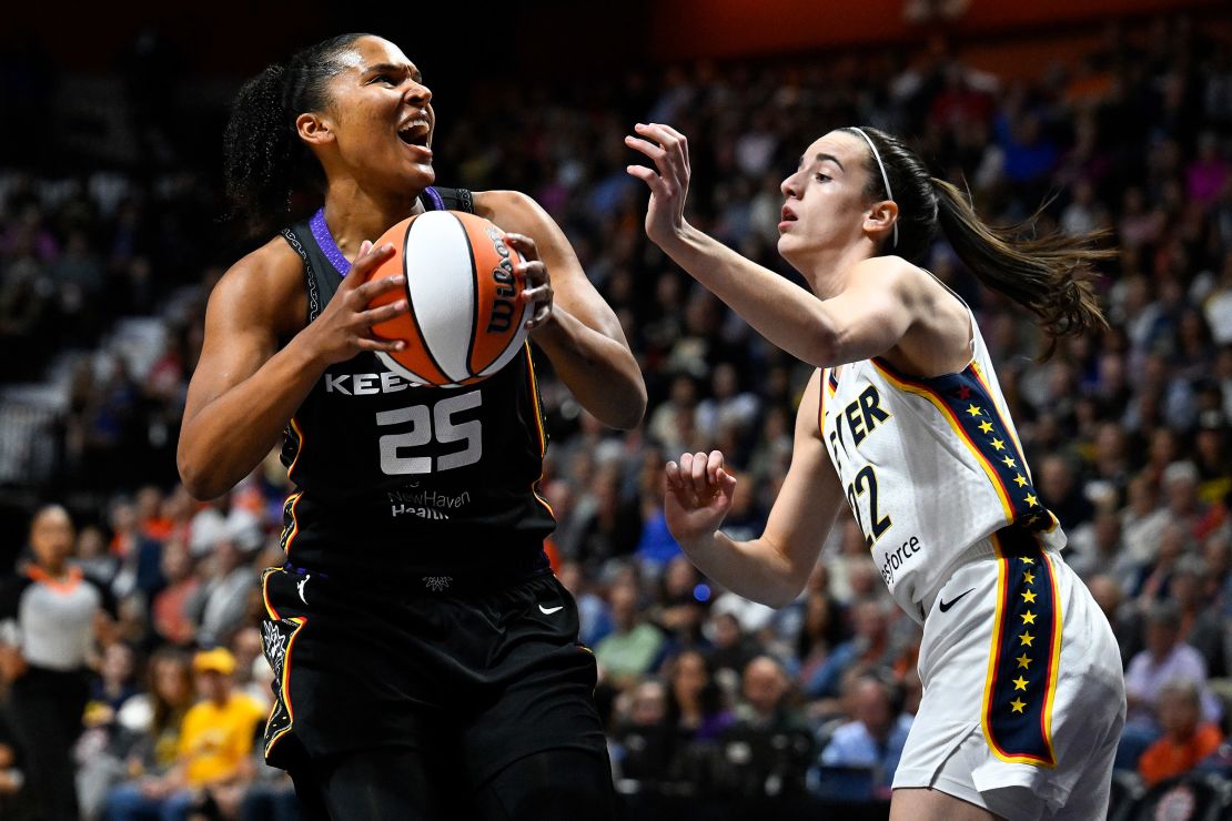 Connecticut Sun forward Alyssa Thomas looks to shoot against Indiana Fever guard Caitlin Clark during Clark's first WNBA game in Uncasville, Connecticut on Tuesday, May 14.