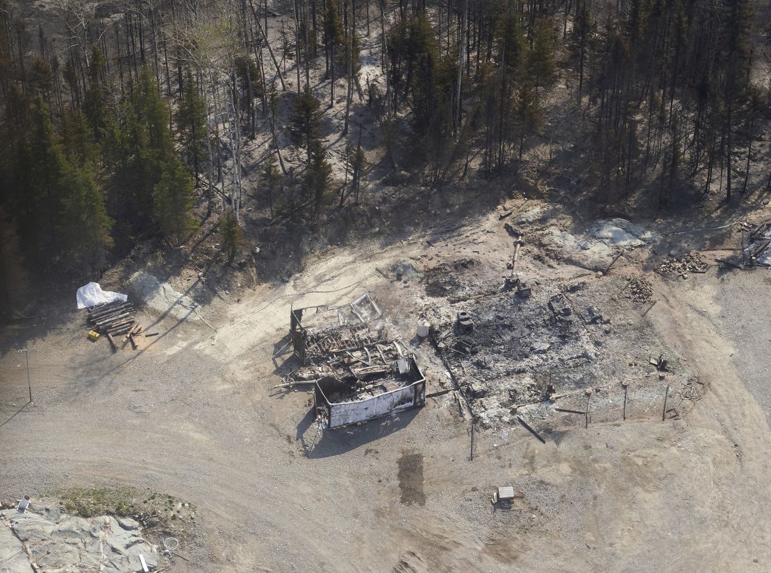 A cottage destroyed by wildfires burning in northern Manitoba, Canada, as seen from a helicopter on Tuesday, May 14, 2024.