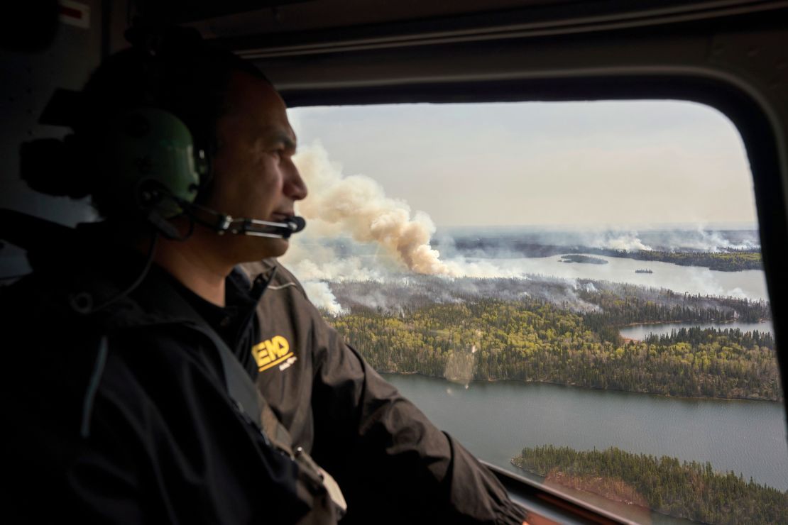 The Premier of Manitoba, Canada, Wab Kinew, surveys wildfires by helicopter which ravaged the north of the province last month.