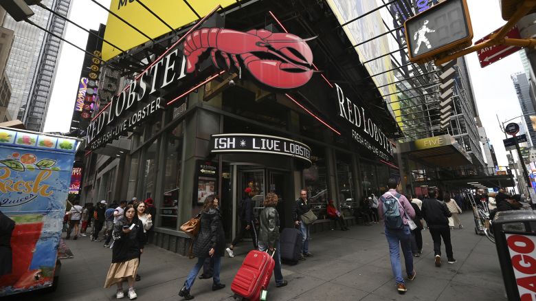 People walk past a Red Lobster seafood restaurant located in Times Square, New York, NY, May 15, 2024.