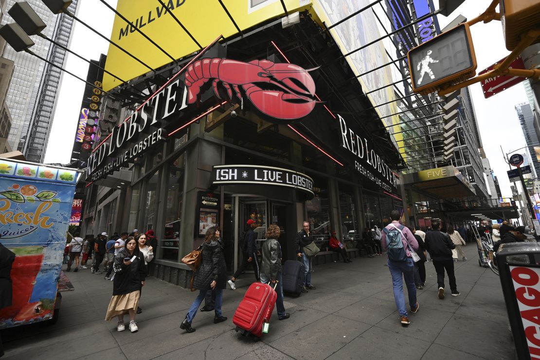 People walk past a Red Lobster seafood restaurant in Times Square, New York, on May 15, 2024.