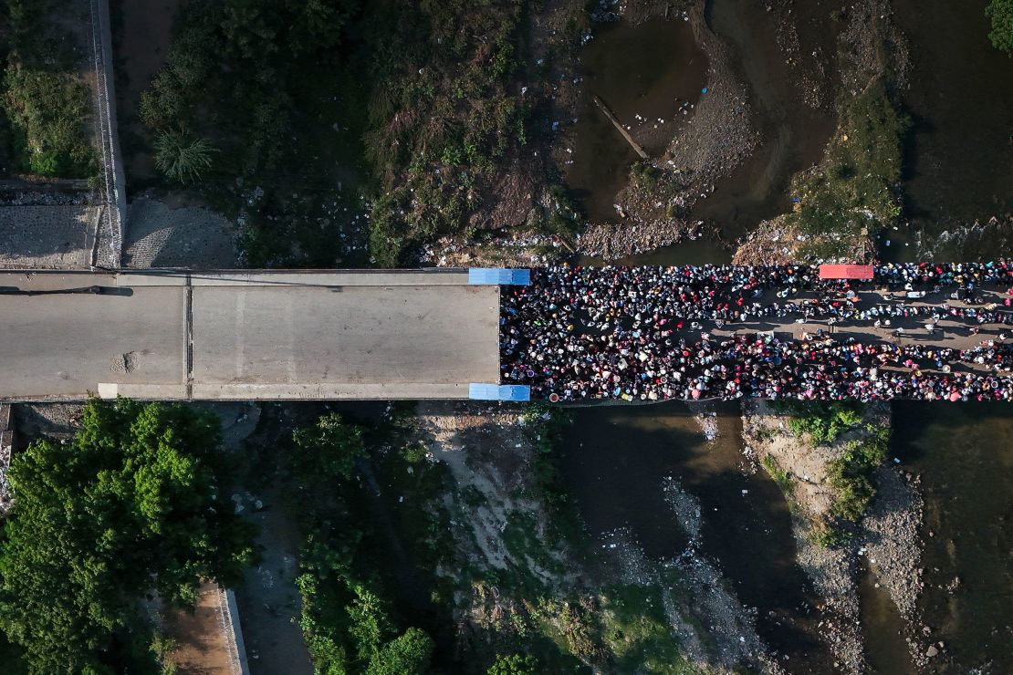 People wait in Ouanaminthe, Haiti to cross into Dajabon, Dominican Republic, Friday, May 17, 2024. The Dominican Republic’s election on May 19 has been marked by calls for more migratory crackdowns and finishing a border wall dividing the countries.