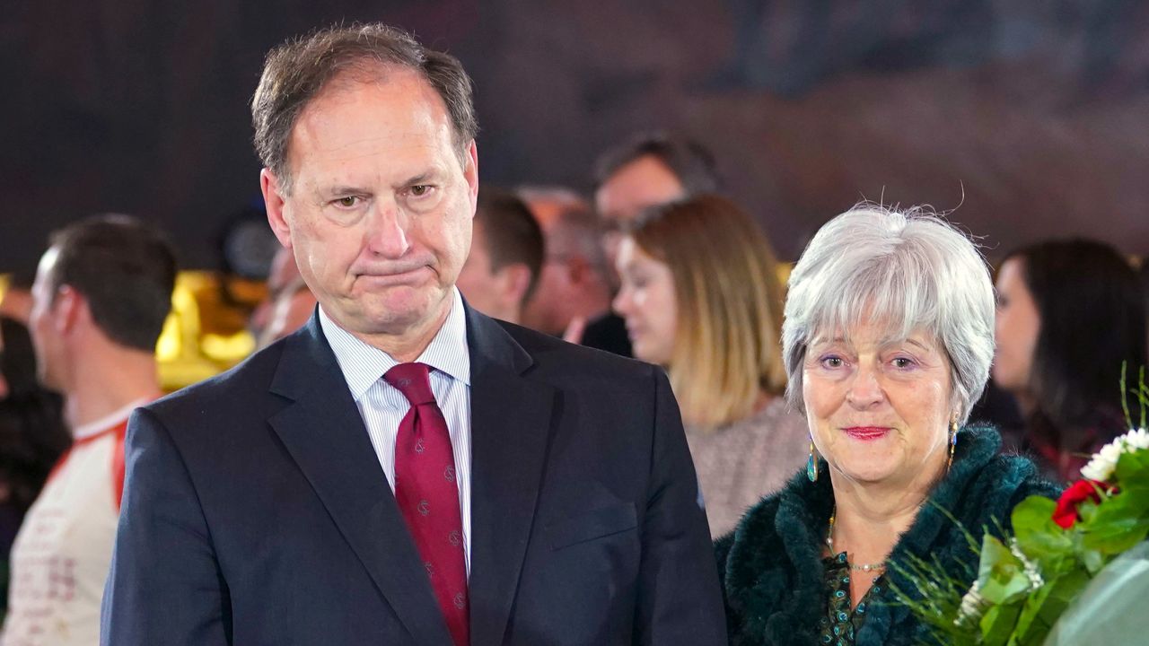 In this file photograph, Supreme Court Justice Samuel Alito Jr., left, and his wife Martha-Ann Alito, pay their respects at the casket of Reverend Billy Graham at the Rotunda of the U.S. Capitol Building in Washington, D.C., on February 28, 2018. An upside-down American flag, a symbol associated with Donald Trump's false claims of election fraud, was displayed outside of Alito's home days after Trump supporters stormed the U.S. Capitol, The New York Times reports. 