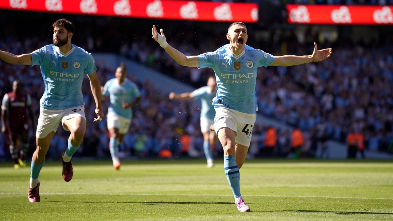 Manchester City's Phil Foden, right, celebrates after scoring his side's opening goal during the English Premier League soccer match between Manchester City and West Ham United at the Etihad Stadium in Manchester, England, Sunday, May 19, 2024.