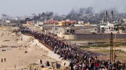 Palestinians are waiting for aid trucks to cross in central Gaza Strip on Sunday, May 19, 2024. (AP Photo/Abdel Kareem Hana)
