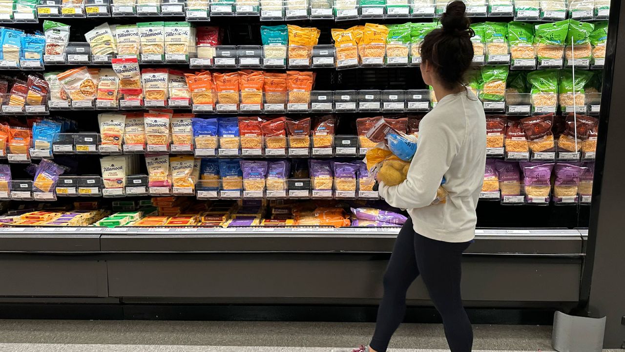 A shopper peruses the refrigerated cheese offerings in a Target store Oct. 4, 2023, in Shridan, Colo.
