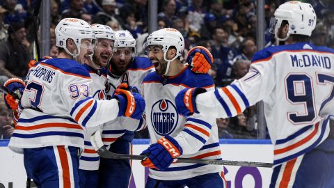 From left to right, Edmonton Oilers' Ryan Nugent-Hopkins, Zach Hyman, Leon Draisaitl, Evan Bouchard and Connor McDavid celebrate after a goal by Nugent-Hopkins during the second period in Game 7 of an NHL hockey Stanley Cup second-round playoff series against the Vancouver Canucks in Vancouver, British Columbia, Monday, May 20, 2024. (Darryl Dyck/The Canadian Press via AP)