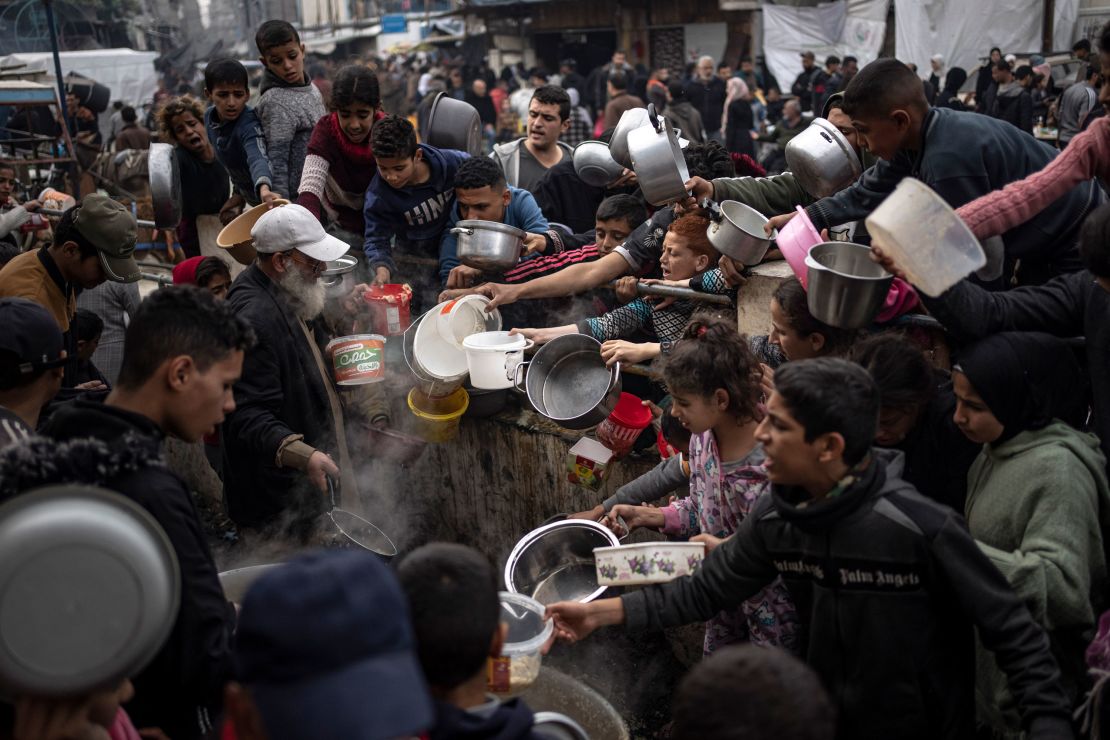 Palestinians line up for a meal in Rafah.