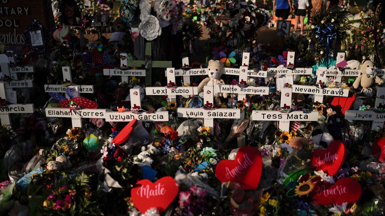 FILE - Flowers are piled around crosses with the names of the victims killed in a school shooting as people visit a memorial at Robb Elementary School to pay their respects May 31, 2022, in Uvalde, Texas. The families of 19 people who were killed or injured in the shooting and their attorneys are set to make an announcement, Wednesday, May 22, 2024. Friday will mark the two-year anniversary of the shooting where a gunman killed 19 students and two teachers. (AP Photo/Jae C. Hong, File)