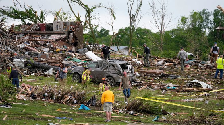 Residents and first responders survey the remains of tornado-ravaged homes in Greenfield, Iowa, on May 21, 2024.
