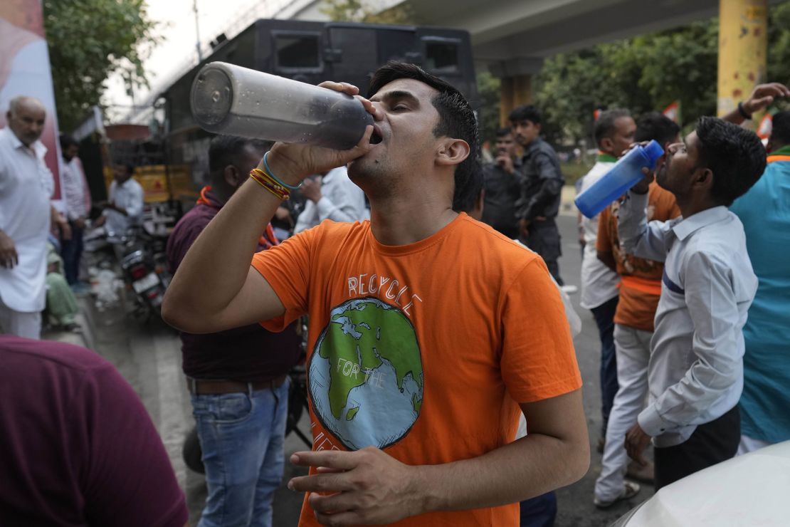 A man drinks water at a roadside stall serving free drinking water to commuters in New Delhi on May 22.