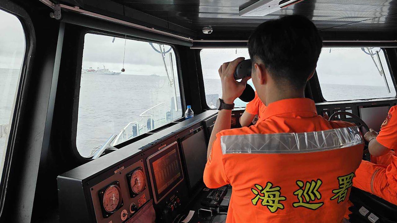 In this photo released by the Taiwan Coast Guard, a Taiwan Coast Guard member monitor Chinese navy vessel operating near the Pengjia Islet north of Taiwan on Thursday, May 23, 2024.