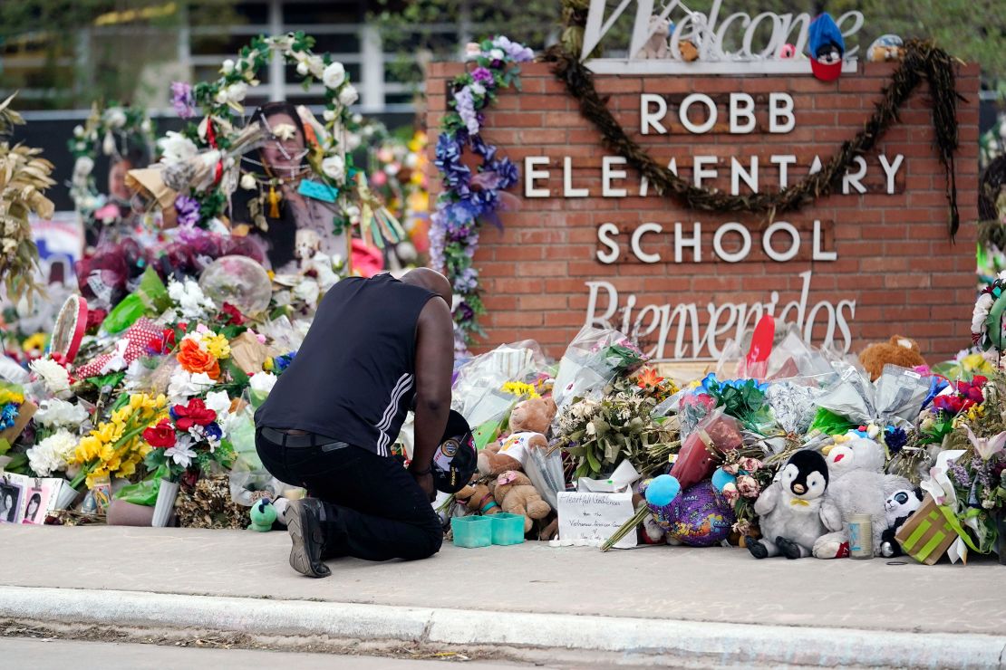 Reggie Daniels pays his respects at a memorial in front of Robb Elementary School, in Uvalde, Texas, on June 9, 2022.