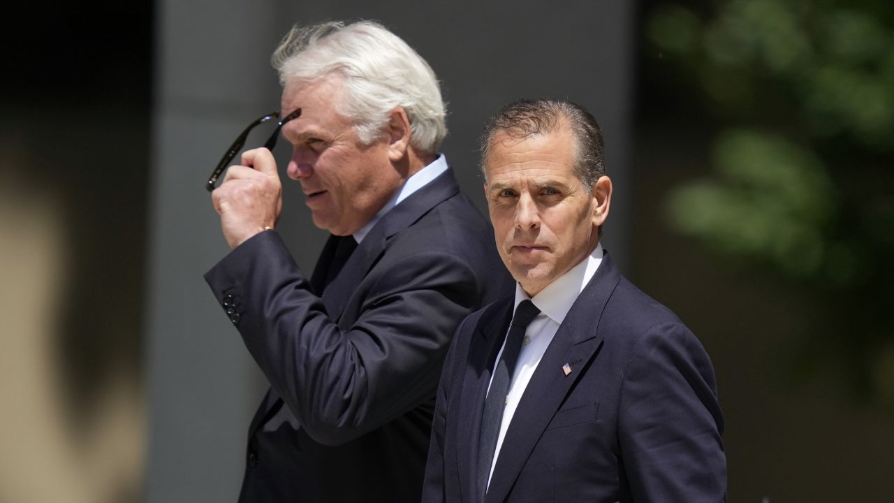 Hunter Biden, right, leaves after a court appearance Friday in Wilmington, Delaware.