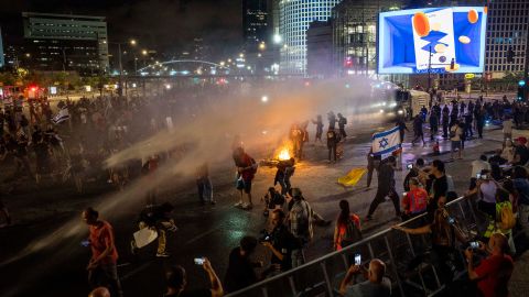 Police use water cannon to disperse demonstrators during a protest against Israeli Prime Minister Benjamin Netanyahu's government, and calling for the release of hostages held in the Gaza Strip by the Hamas militant group, in Tel Aviv, Israel, Saturday, May 25, 2024. (AP Photo/Ariel Schalit)