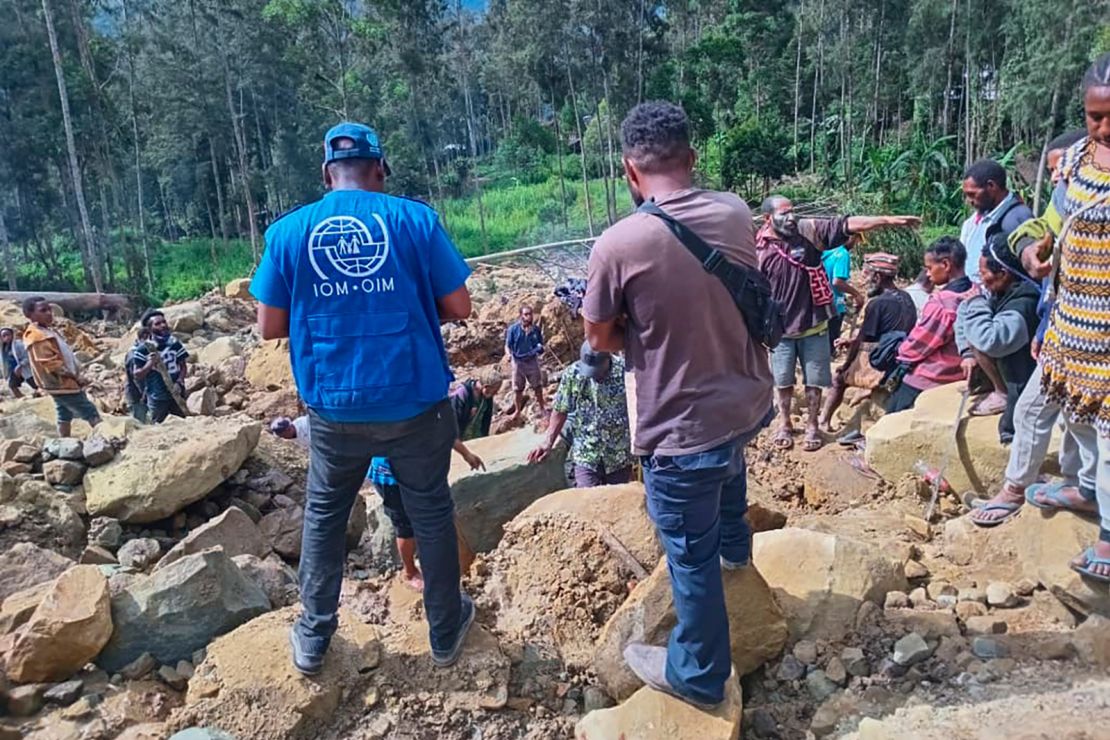 Villagers scour for victims of the landslide in Yambali village on Sunday.