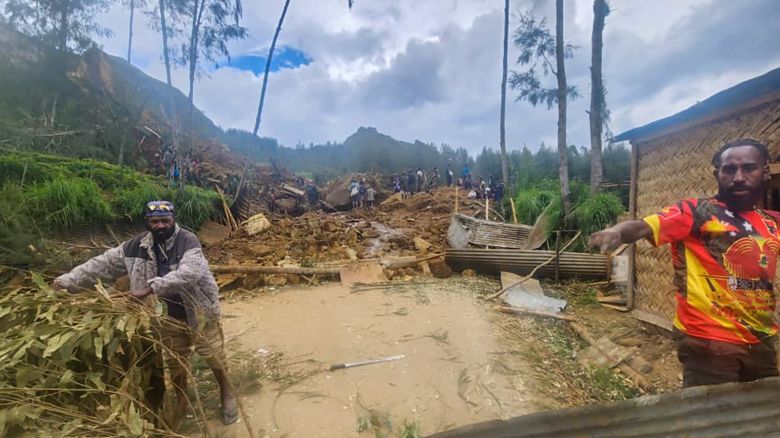Villagers search through a landslide in Yambali in the Highlands of Papua New Guinea, Sunday, May 26, 2024. The International Organization for Migration has increased its estimate of the death toll from a massive landslide Friday May 24 in Papua New Guinea to more than 670.