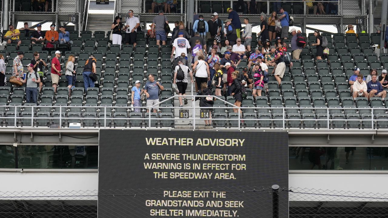 Fans exit the grandstands after a serve thunderstorm warning was issued for the area around the Indianapolis 500 auto race at Indianapolis Motor Speedway in Indianapolis, Sunday, May 26, 2024.