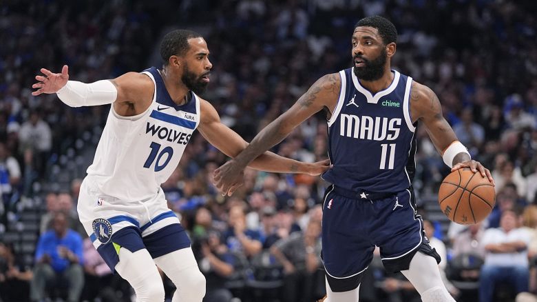 Dallas Mavericks guard Kyrie Irving (11) drives around Minnesota Timberwolves guard Mike Conley (10) during the second half in Game 3 of the NBA basketball Western Conference finals, Sunday, May 26, 2024, in Dallas. (AP Photo/Julio Cortez)