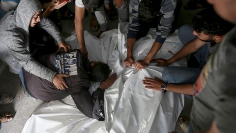 Palestinians mourn over the bodies of relatives killed in an Israeli airstrike, at a morgue in Rafah, Gaza Strip, Monday, May 27, 2024. Palestinian health workers said Israeli airstrikes Sunday killed at least 35 people sheltering in a tent camp for displaced people. Israel's army confirmed the strike and said it hit a Hamas installation and killed two senior Hamas militants. (AP Photo/Jehad Alshrafi)