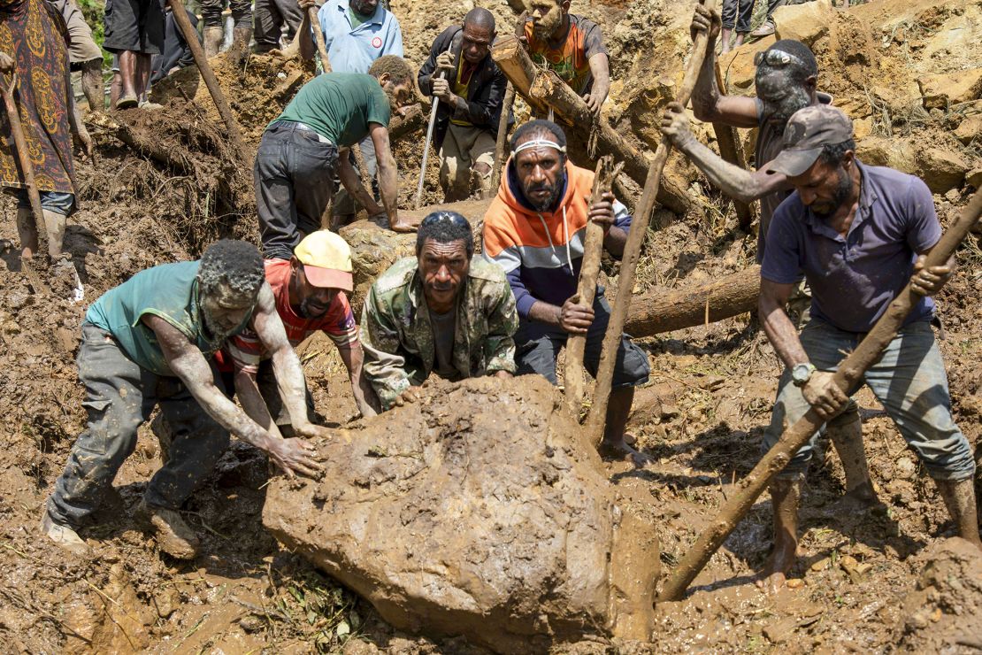 Villagers sifted through rubble while awaiting rescue crews to arrive.