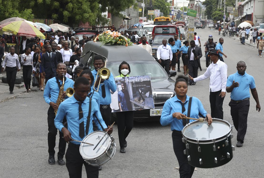 A funeral procession for mission director Judes Montis, killed by gangs alongside the two US missionary members, makes its way to the cemetery after his funeral ceremony in Port-au-Prince on Tuesday.