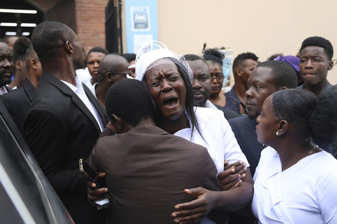 Eunide Majeur Montis, the wife of slain mission director Judes Montis, cries after attending his funeral service on May 28.