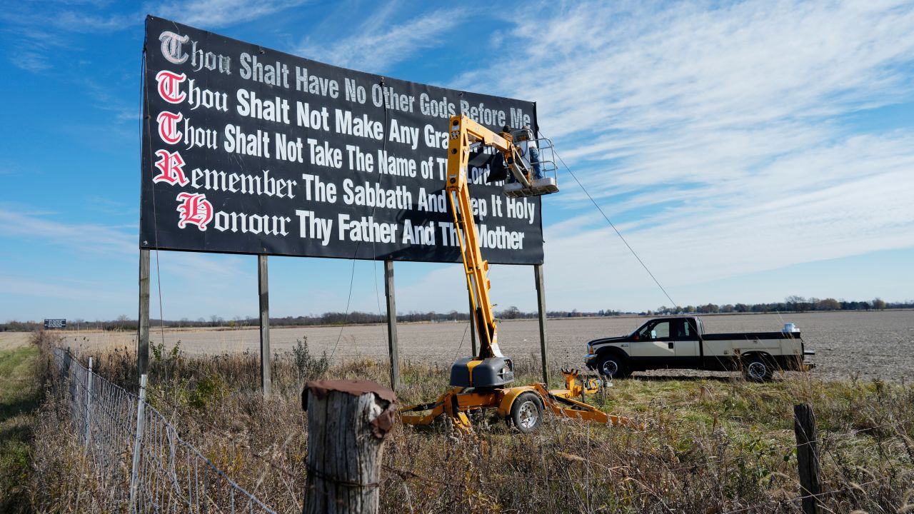 Workers repaint a Ten Commandments billboard off of Interstate 71 on Election Day near Chenoweth, Ohio, Tuesday, Nov. 7, 2023. Louisiana last week enacted legislation to require that the Ten Commandments be displayed in every public school classroom.