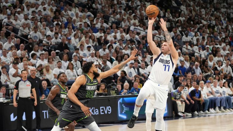 Dallas Mavericks guard Luka Doncic shoots over Minnesota Timberwolves center Karl-Anthony Towns during Game 5 of the Western Conference finals in the NBA basketball playoffs on May 30, 2024, in Minneapolis.
