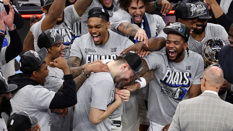Dallas Mavericks guard Luka Dončić, center, celebrates with teammates after Game 5 of the Western Conference finals in the NBA basketball playoffs against the Minnesota Timberwolves on Thursday in Minneapolis.