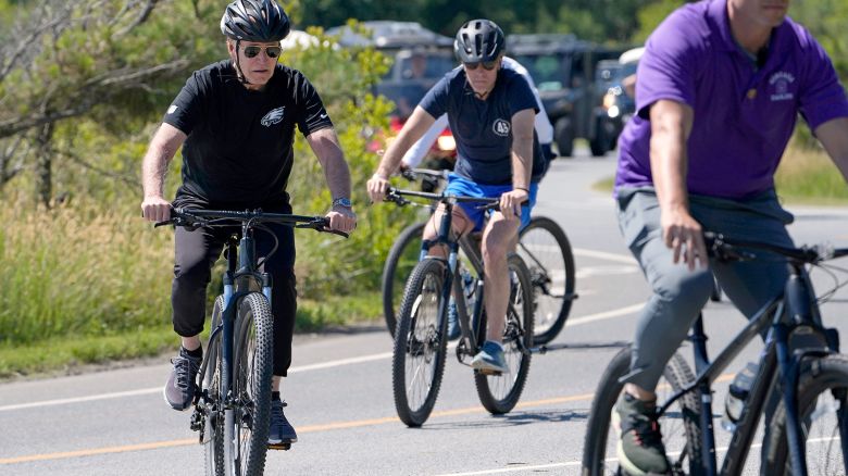 President Joe Biden and his son Hunter Biden, center, bike together near Rehoboth Beach, Delaware, on June 1, 2024.