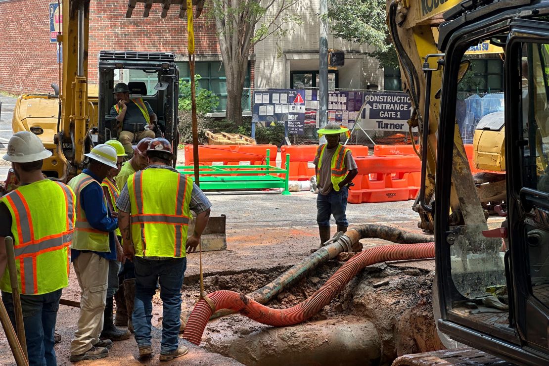 Workers try to fix a leaking water main junction on Monday in Atlanta.