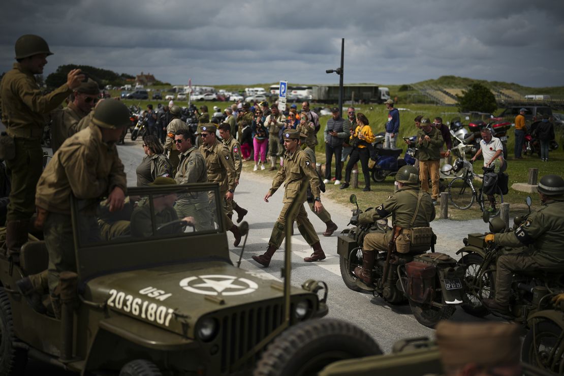 Reenactors participate in a ceremony Tuesday at Utah Beach near Sainte-Marie-du-Mont, France, in celebrations marking the 80th anniversary of D-Day.