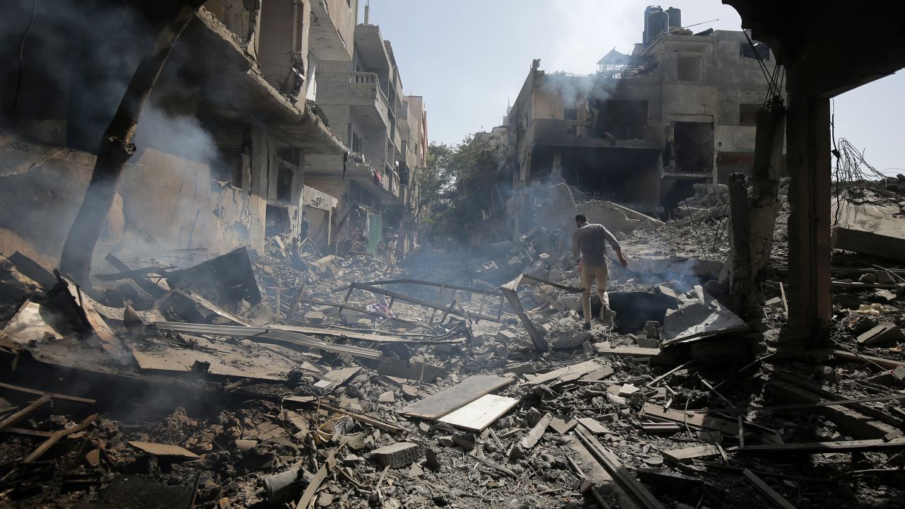 Palestinians look at the aftermath of the Israeli bombing in Nuseirat refugee camp, Gaza Strip, Saturday, June 8, 2024.