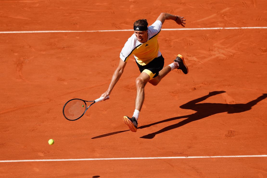 Zverev, playing in his first French Open final, chases down a shot against Alcaraz.