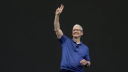 Apple CEO Tim Cook waves while speaking at an announcement of new products on the Apple campus in Cupertino, Calif., Monday, June 10, 2024.