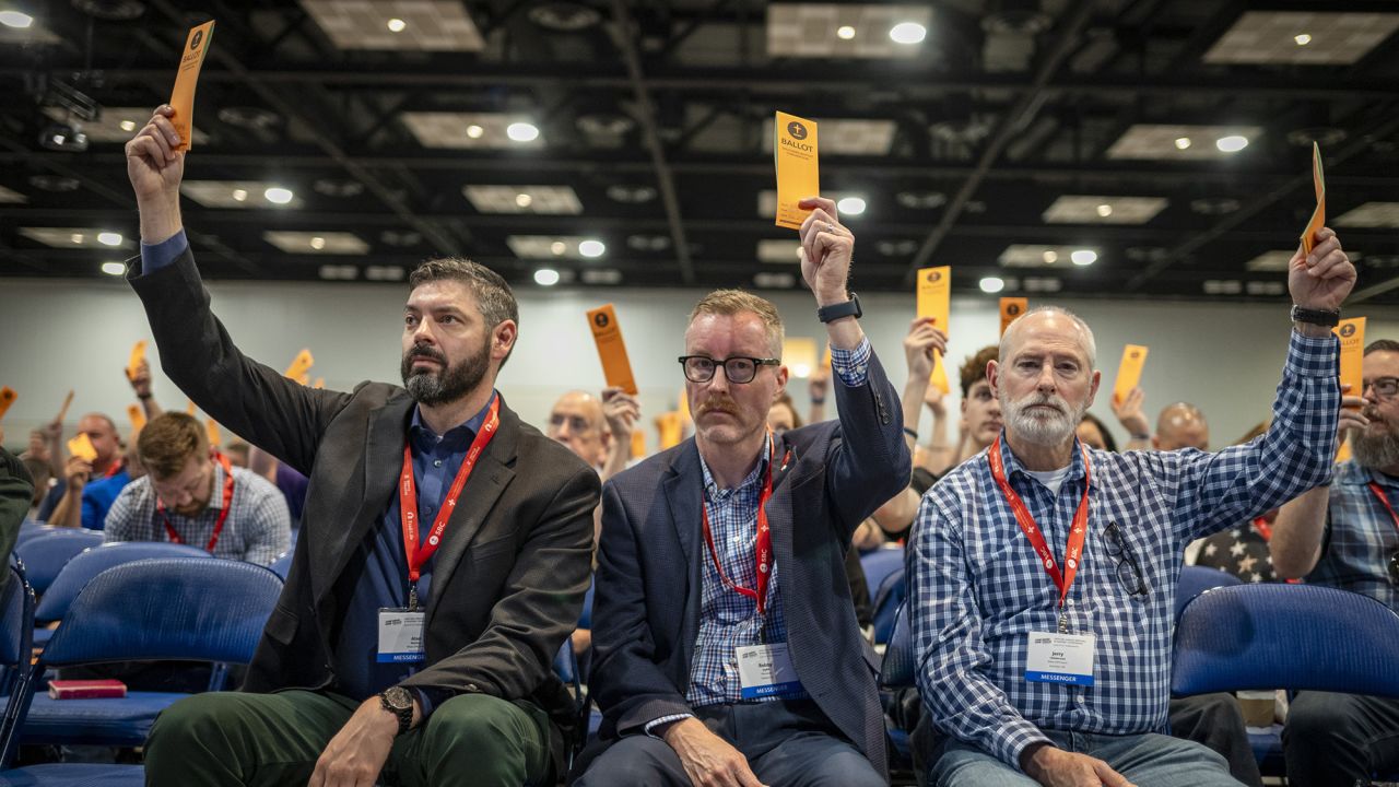 Messengers raise their ballots in support of a motion put up for vote during a Southern Baptist Convention annual meeting Tuesday, June 11, 2024, in Indianapolis. (AP Photo/Doug McSchooler)