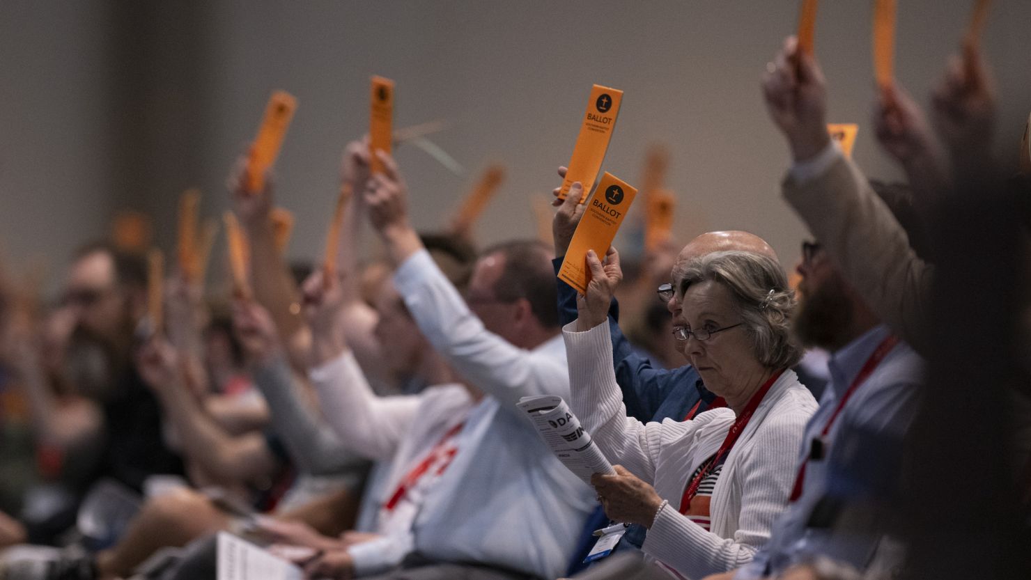 Messengers raise their ballots in support of a motion put up for vote during the Southern Baptist Convention's annual meeting on June 11, 2024, in Indianapolis.