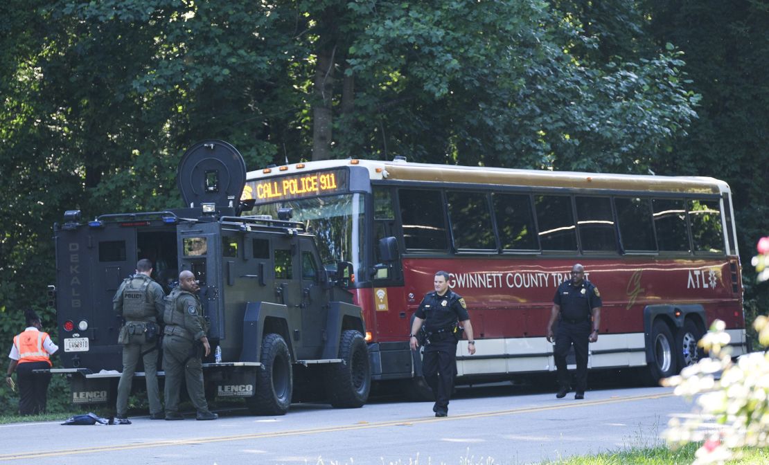 A hijacked commuter bus sits in the road where it was stopped after a lengthy police chase Tuesday.