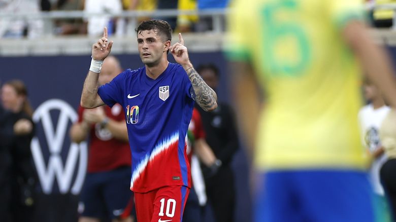 Christian Pulisic celebrates after scoring the US's goal against Brazil.