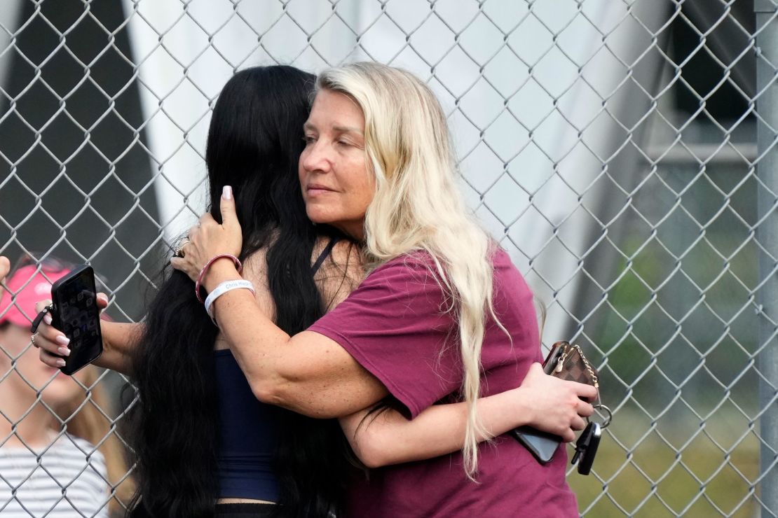 Joanne Wallace, right, former special education teacher at Marjory Stoneman Douglas High School, hugs an onlooker during the demolition.