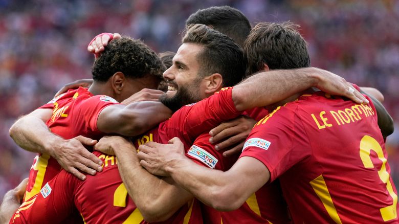 Spain players celebrate after Dani Carvajal, back to camera, scored their side's third goal during a Group B match between Spain and Croatia at the Euro 2024 soccer tournament in Berlin, Germany, Saturday, June 15, 2024.