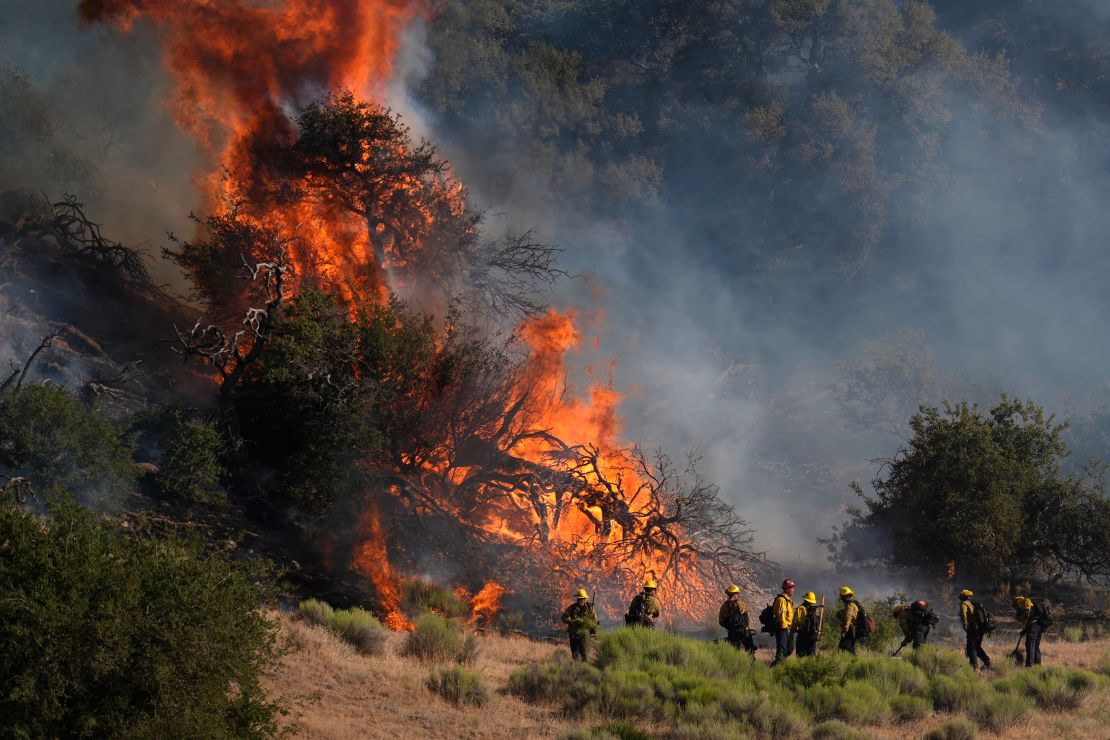 Firefighters work against the advancing Post Fire on Saturday in Gorman, California.