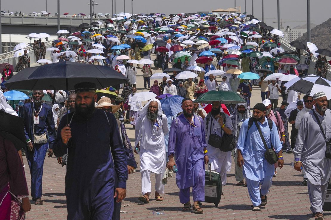 Muslim pilgrims use umbrellas to shield themselves from the sun as they arrive for the annual Hajj pilgrimage, near the holy city of Mecca, Saudi Arabia, on June 18.