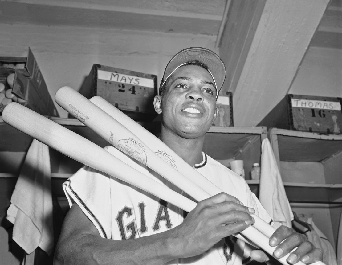 FILE - New York Giants' centerfielder Willie Mays flashes smile in clubhouse at the Polo Grounds in New York after clouting his 20th triple of the season in 1957.