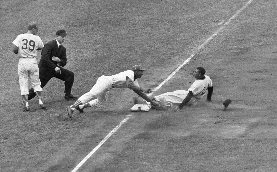 New York Giants star Willie Mays loses his hat as the slides into third, starting at first on an infield hit in the sixth inning of game against the Chicago Cubs on May 22, 1957, in Chicago.