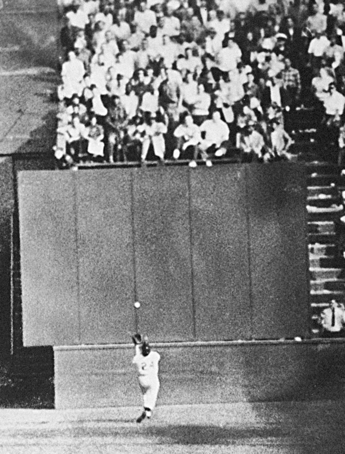 Mays, with his back to the plate, gets under a 450-foot blast off the bat of Cleveland Indians first baseman Vic Wertz to pull the ball down in front of the bleachers wall in the eighth inning of Game 1 of the World Series at the Polo Grounds in New York on September 29, 1954.