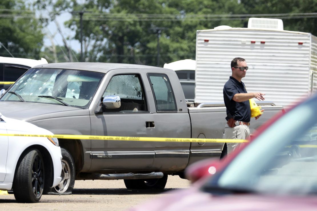 A law enforcement officer works the scene of the grocery store shooting on Friday.