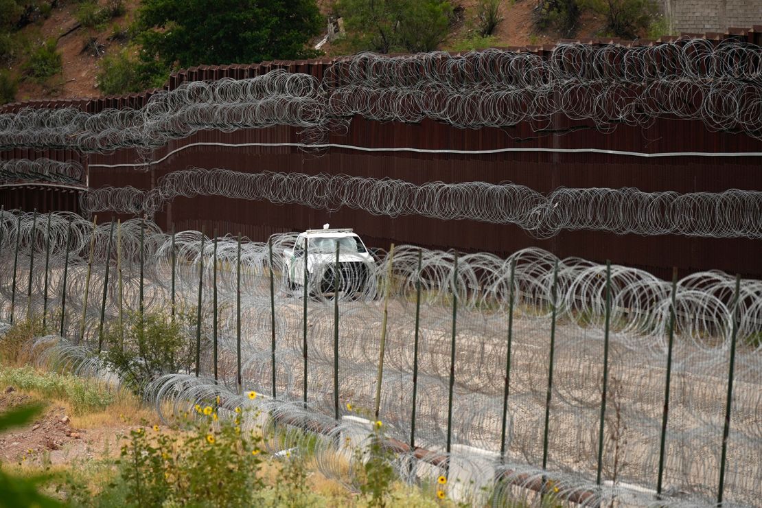 A vehicle drives along the U.S. side of the US-Mexico border wall in Nogales, Ariz. on Tuesday, June 25, 2024.